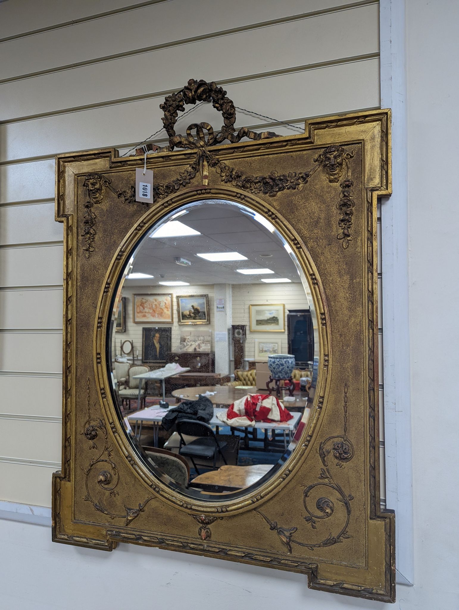 A Victorian style rectangular giltwood and gesso wall mirror, floral swag to top, with oval plate, width 70cm, height 92cm